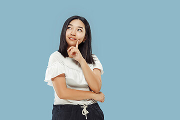 Image showing Korean young woman\'s half-length portrait on blue background