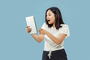 Image showing Korean young woman\'s half-length portrait on blue background