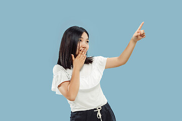 Image showing Korean young woman\'s half-length portrait on blue background