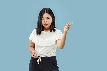 Image showing Korean young woman\'s half-length portrait on blue background