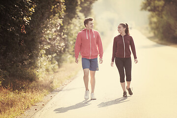 Image showing young couple jogging along a country road