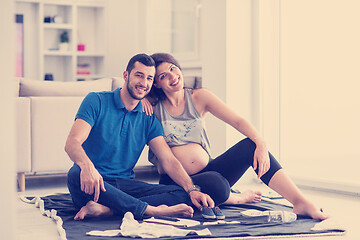 Image showing pregnant couple checking a list of things for their unborn baby