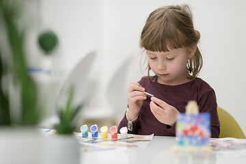 Image showing little girl painting on canvas