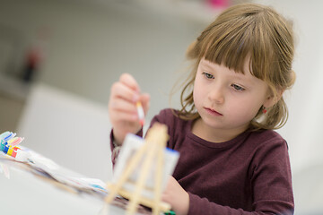 Image showing little girl painting on canvas