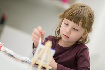 Image showing little girl painting on canvas