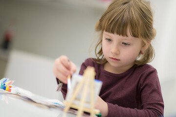 Image showing little girl painting on canvas