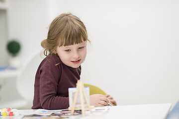 Image showing little girl painting on canvas