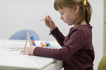 Image showing little girl painting on canvas