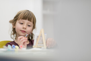 Image showing little girl painting on canvas