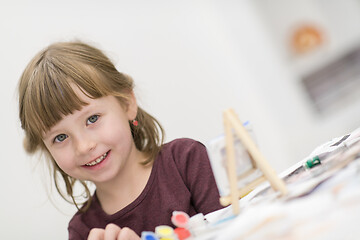 Image showing little girl painting on canvas