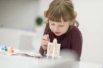 Image showing little girl painting on canvas