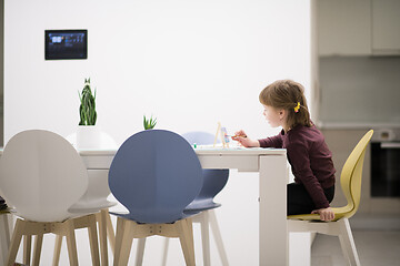 Image showing little girl painting on canvas