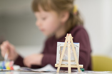 Image showing little girl painting on canvas