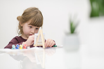 Image showing little girl painting on canvas