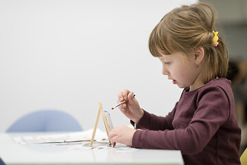 Image showing little girl painting on canvas