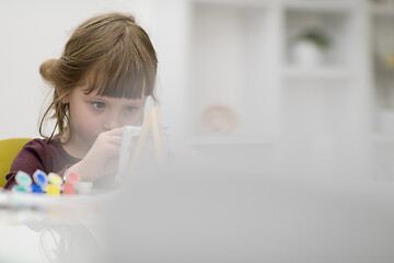 Image showing little girl painting on canvas