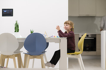 Image showing little girl painting on canvas