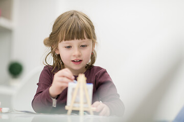 Image showing little girl painting on canvas