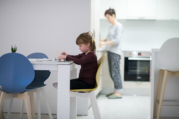 Image showing little girl painting on canvas