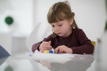 Image showing little girl painting on canvas