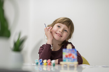 Image showing little girl painting on canvas