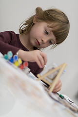 Image showing little girl painting on canvas