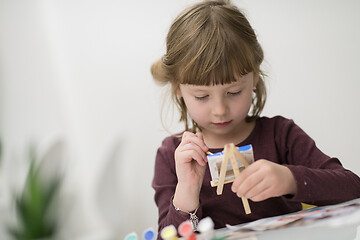 Image showing little girl painting on canvas