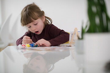 Image showing little girl painting on canvas