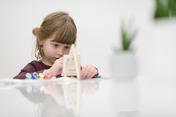 Image showing little girl painting on canvas