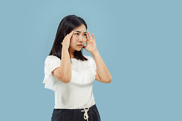 Image showing Korean young woman\'s half-length portrait on blue background