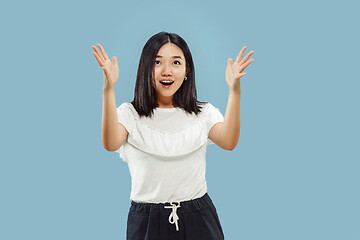 Image showing Korean young woman\'s half-length portrait on blue background