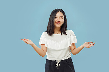 Image showing Korean young woman\'s half-length portrait on blue background