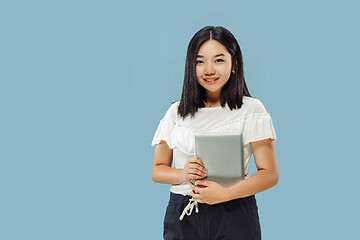 Image showing Korean young woman\'s half-length portrait on blue background