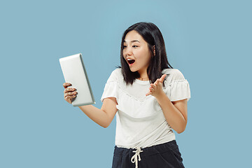 Image showing Korean young woman\'s half-length portrait on blue background