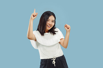 Image showing Korean young woman\'s half-length portrait on blue background