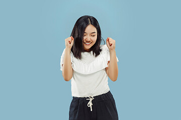 Image showing Korean young woman\'s half-length portrait on blue background