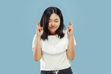 Image showing Korean young woman\'s half-length portrait on blue background