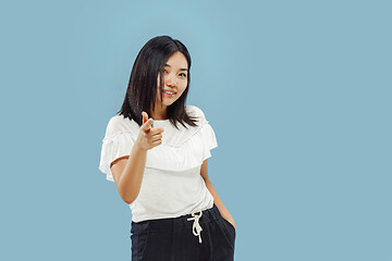 Image showing Korean young woman\'s half-length portrait on blue background