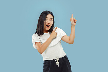 Image showing Korean young woman\'s half-length portrait on blue background