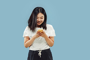 Image showing Korean young woman\'s half-length portrait on blue background