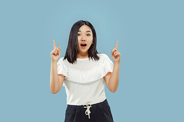 Image showing Korean young woman\'s half-length portrait on blue background