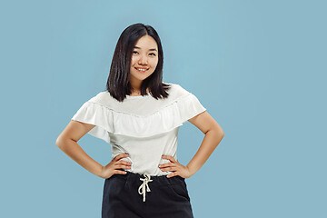 Image showing Korean young woman\'s half-length portrait on blue background