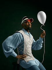 Image showing Young man as a medieval knight on dark background