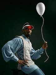 Image showing Young man as a medieval knight on dark background