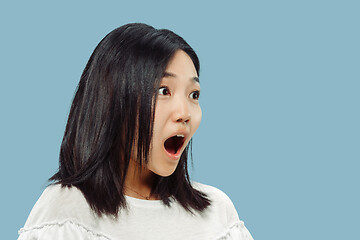 Image showing Korean young woman\'s half-length portrait on blue background