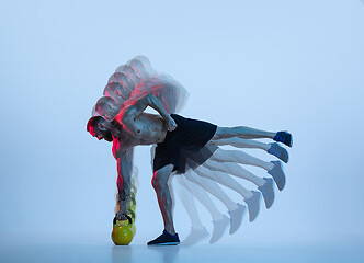 Image showing Young caucasian bodybuilder training over blue background