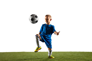 Image showing Young boy as a soccer or football player on white studio background