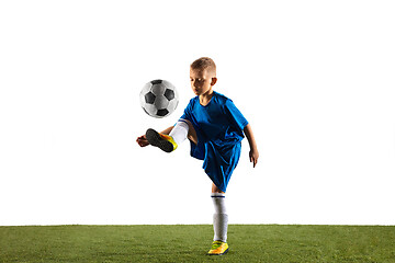 Image showing Young boy as a soccer or football player on white studio background