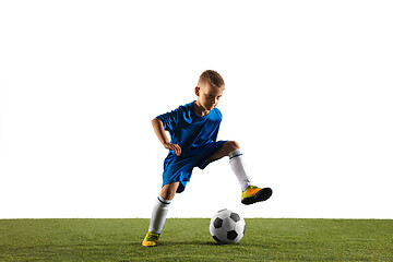 Image showing Young boy as a soccer or football player on white studio background