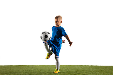 Image showing Young boy as a soccer or football player on white studio background